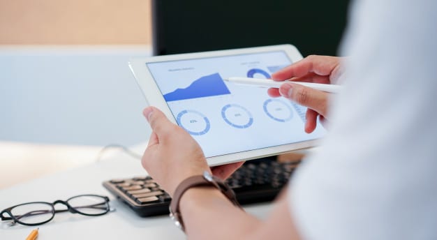 businessman-using-pen-planning-financial-strategy-tablet-with-dashboard_42708-871