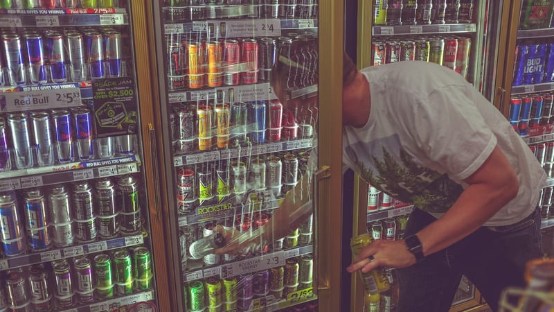 Energy drinks lining a store cooler
