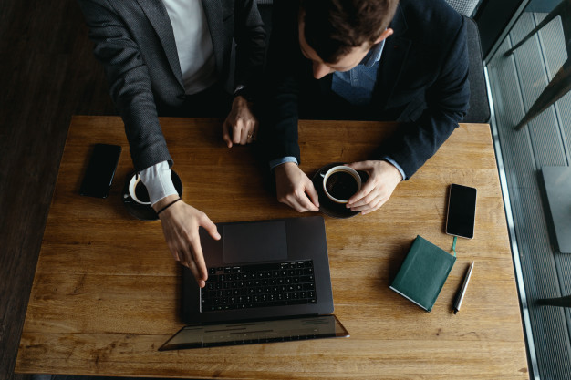 two businessmen pointing laptop screen while discussing 158595 5325 1